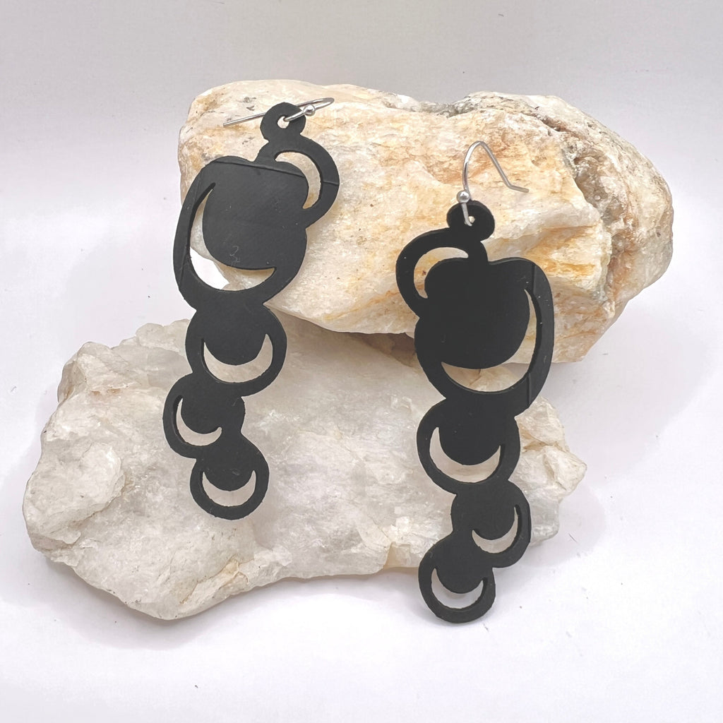 These abstract moons are just the thing to make a statement with either jeans or a little black dress or anything in between. Lightweight and waterproof these earrings go with the tides. Earring is laser cut from up-cycled bicycle inner tubes, made to order in the USA with stainless steel findings. Wear the rubber nut backs because these little earrings will fly away!