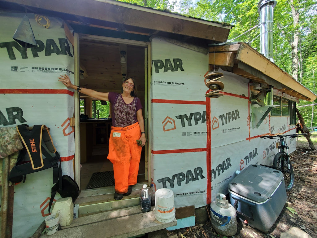 Abby standing in the doorway of the first of many tiny homes she plans to build on her property.