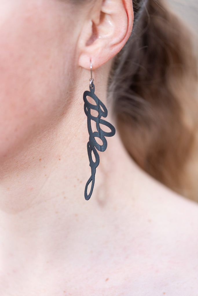 Passing notes rubber earring, 3" of upcycled bike tube rubber, made with stainless steel findings.