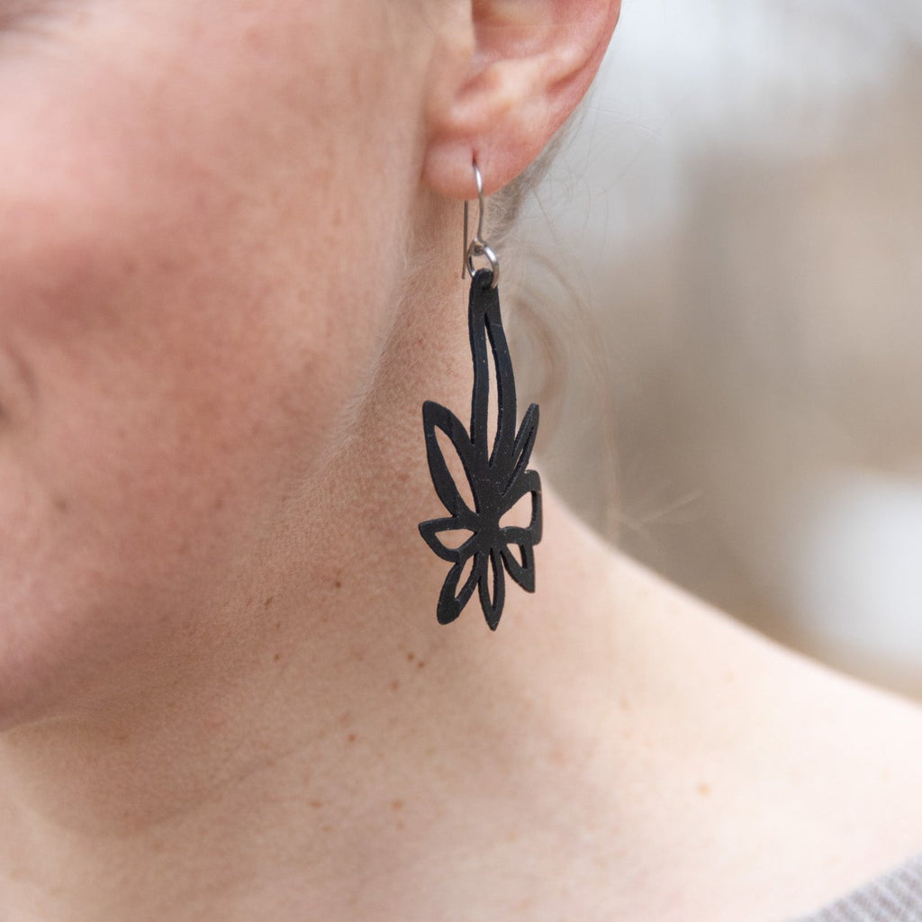 Abstract Lily rubber earring is inspired by our trip to Nepal and the motifs on the monasteries. Upcycled, laser cut bike tube rubber. Stainless steel ear wires. Made in the USA.