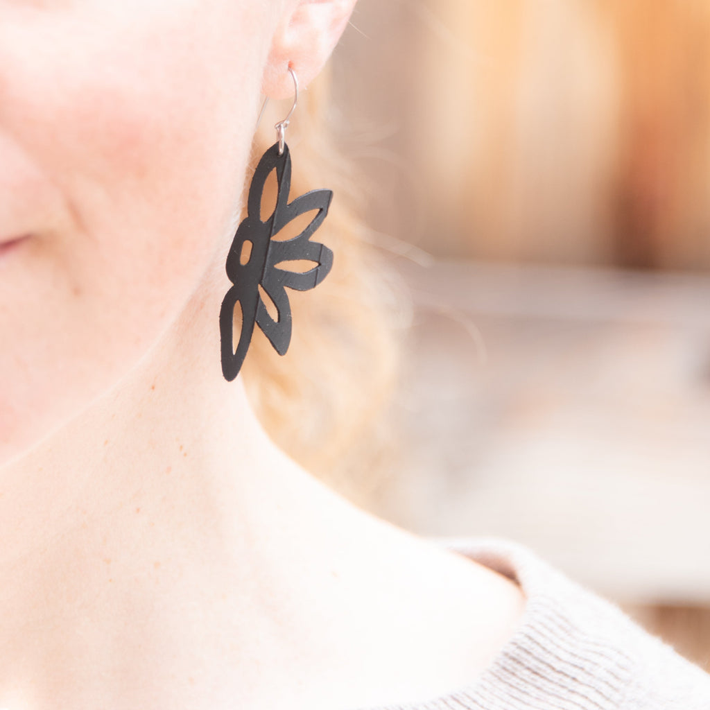 Half Flower rubber earring is made with upcycled bike tubes and is lasercut and then assembled into lightweight jewelry. Stainless steel ear wires. Made in the USA.