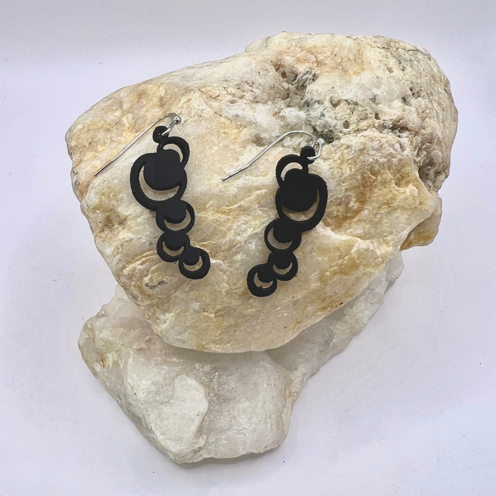 These abstract moons are just the thing to make a statement with either jeans or a little black dress or anything in between. Lightweight and waterproof these earrings go with the tides. Earring is laser cut from up-cycled bicycle inner tubes, made to order in the USA with stainless steel findings. Wear the rubber nut backs because these little earrings will fly away!