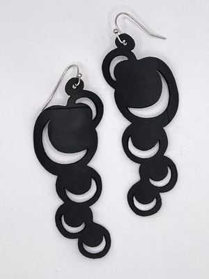 These abstract moons are just the thing to make a statement with either jeans or a little black dress or anything in between. Lightweight and waterproof these earrings go with the tides. Earring is laser cut from up-cycled bicycle inner tubes, made to order in the USA with stainless steel findings. Wear the rubber nut backs because these little earrings will fly away!