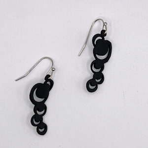 These abstract moons are just the thing to make a statement with either jeans or a little black dress or anything in between. Lightweight and waterproof these earrings go with the tides. Earring is laser cut from up-cycled bicycle inner tubes, made to order in the USA with stainless steel findings. Wear the rubber nut backs because these little earrings will fly away!