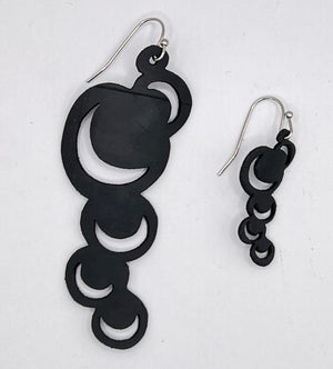 These abstract moons are just the thing to make a statement with either jeans or a little black dress or anything in between. Lightweight and waterproof these earrings go with the tides. Earring is laser cut from up-cycled bicycle inner tubes, made to order in the USA with stainless steel findings. Wear the rubber nut backs because these little earrings will fly away!