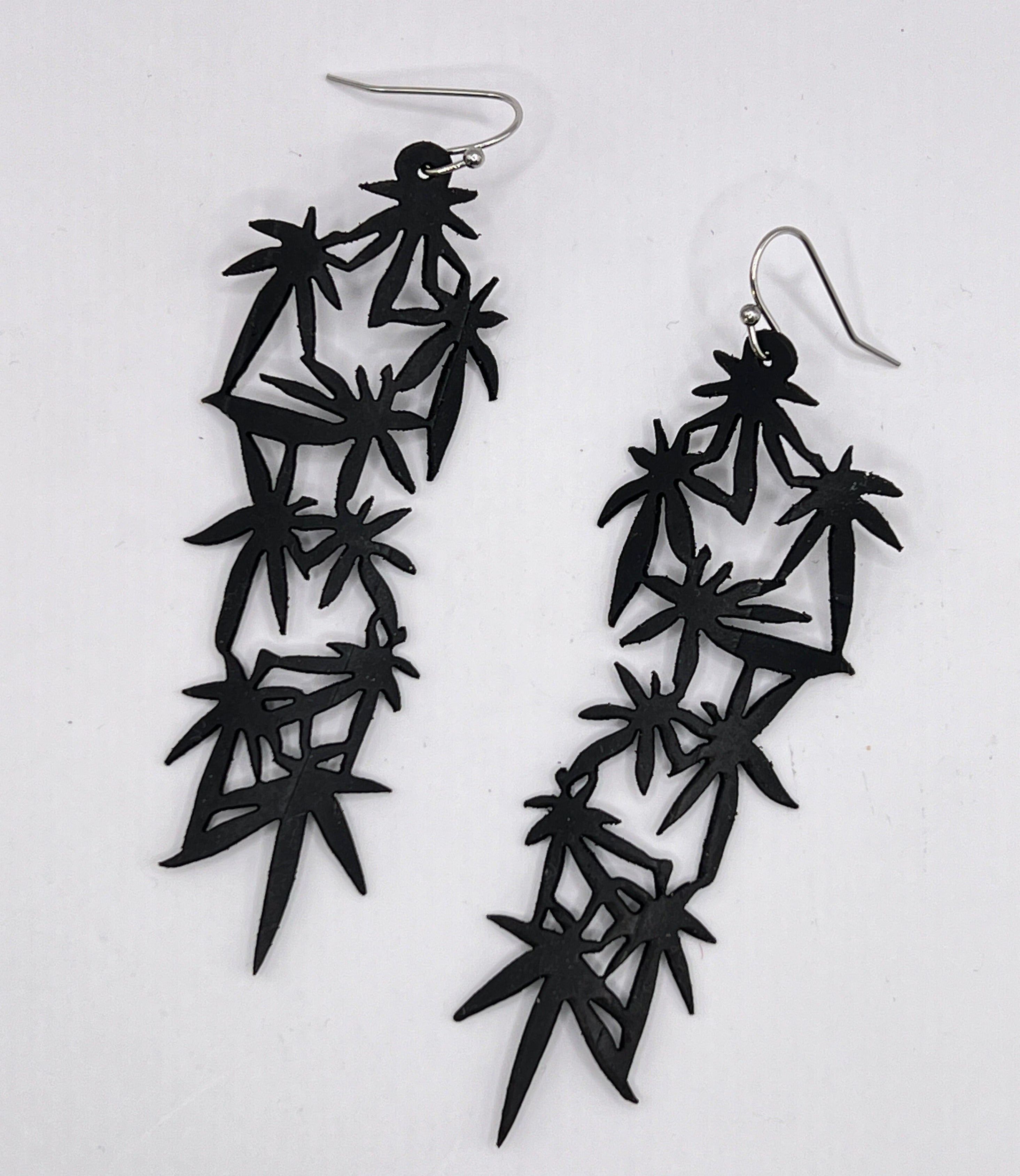 Long overdue the Mary Jane collection 2.0 is here! Abstract and yet playful this nod to a special plant is whimsically subtle. This earring is approximately 3" long and is laser cut from up-cycled bicycle inner tubes, made to order in the USA with stainless steel findings. Wear the rubber nut backs because these earrings will fly away!