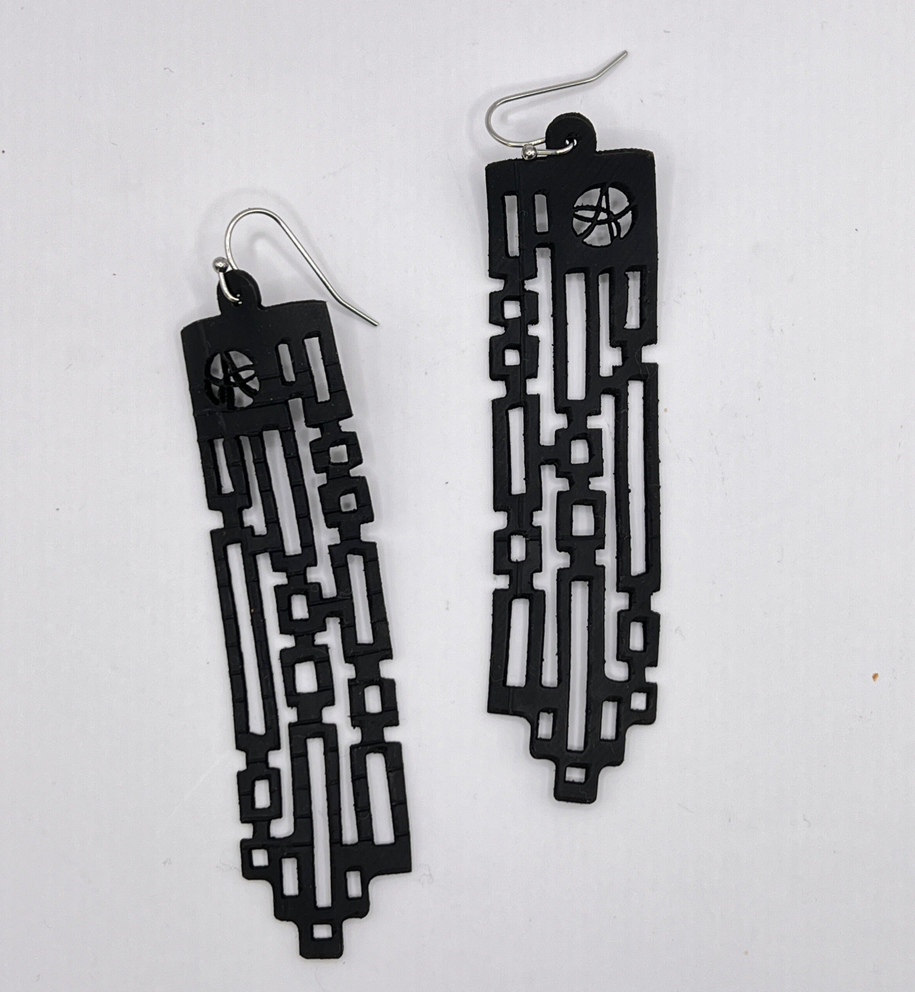 Squares and rectangles or ones and zeros, everything has a pattern. What pattern do you see? What do you make of these earrings? Earring is laser cut from up-cycled bicycle inner tubes, made to order in the USA with stainless steel findings. Wear the rubber nut backs because these little earrings will fly away!